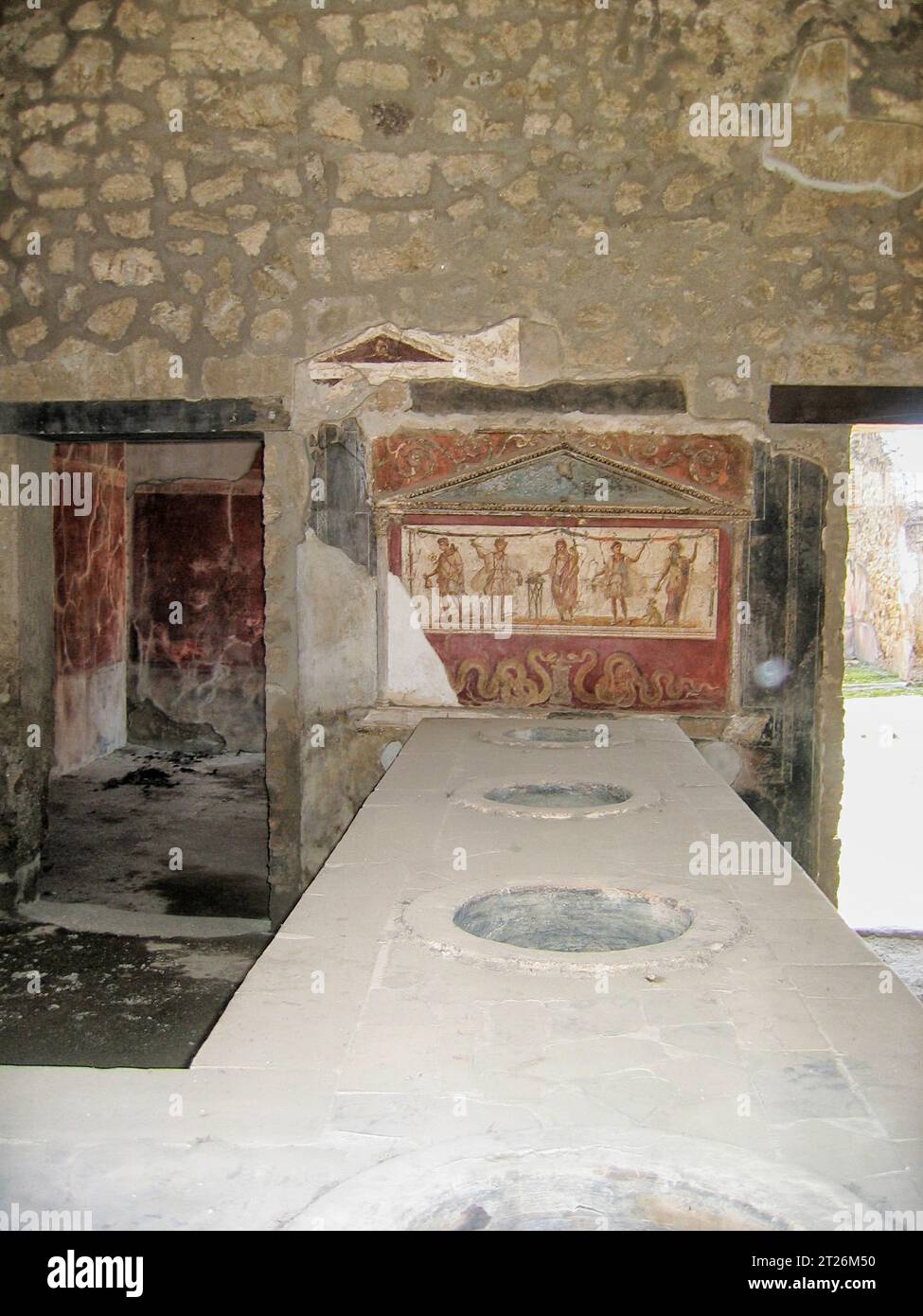 House and Thermopolium of Vetutius Placidus on via dell’Abbondanza (Casa e Thermopolium di Vetutius Placidus). Marble counter with holes for amphorae, Stock Photo
