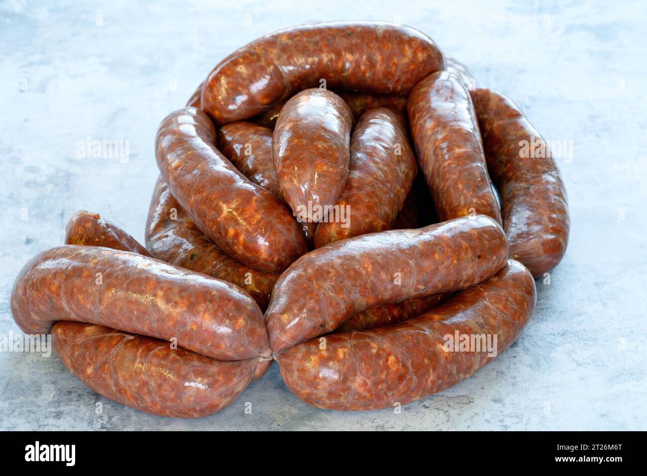 A fiery and flavourful spreadable sausage perfect for adding a kick to your dishes. The nduja is shown in close-up, with its vibrant red contrasting a Stock Photo