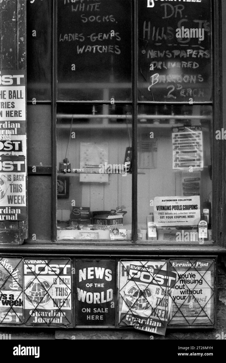 Corner newsagents shop displaying adverts for newspapers and pools