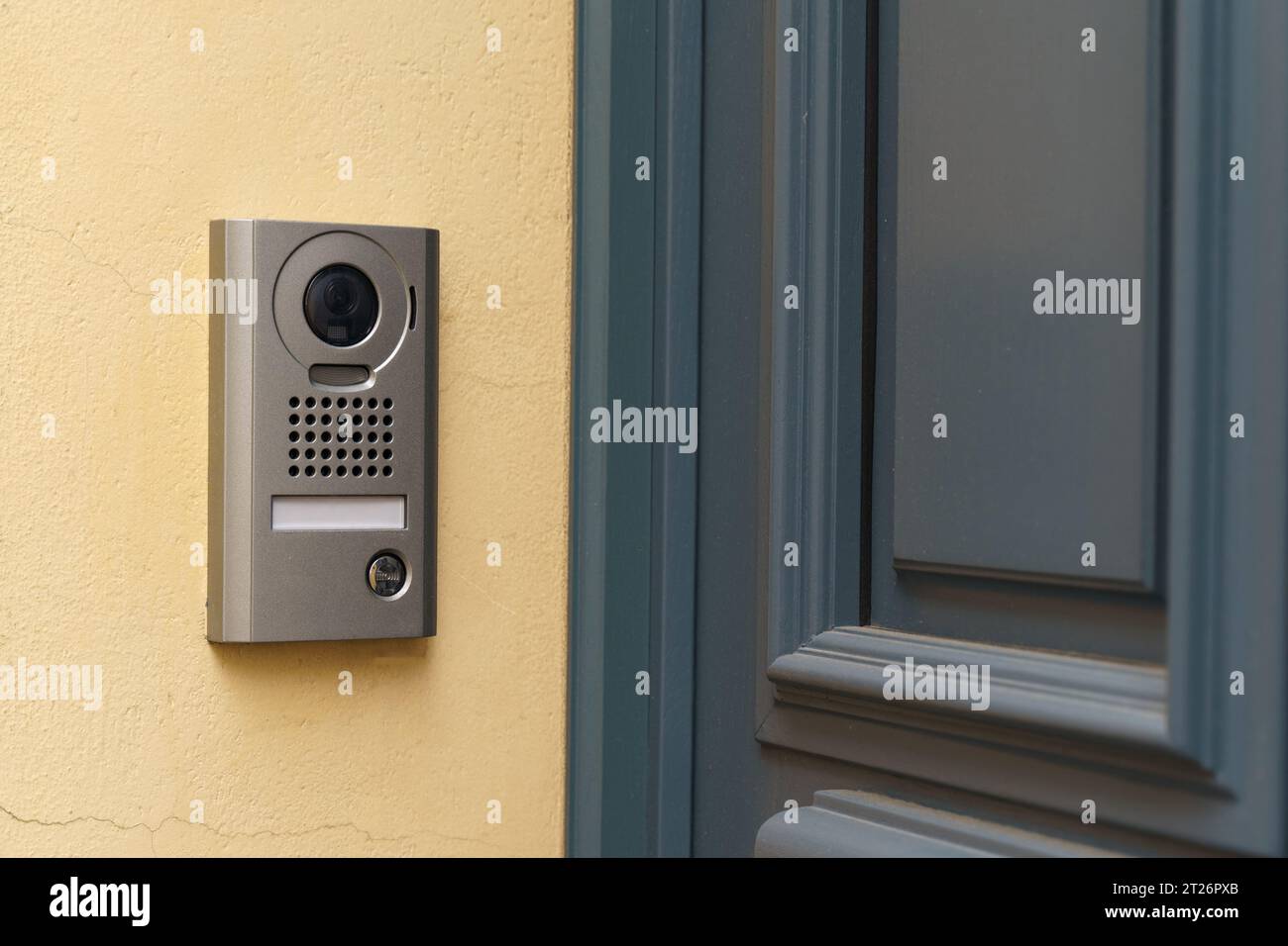 A modern surveillance camera is installed on the front door. Close-up ...