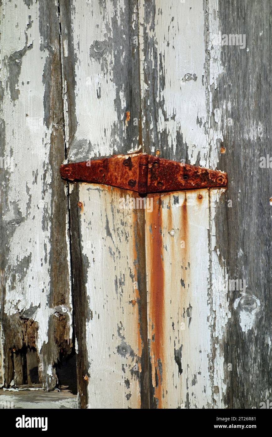 rusty hinge and cracking paint Stock Photo