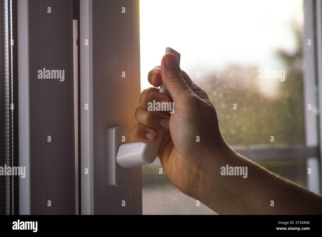 A woman opening a window Stock Photo - Alamy