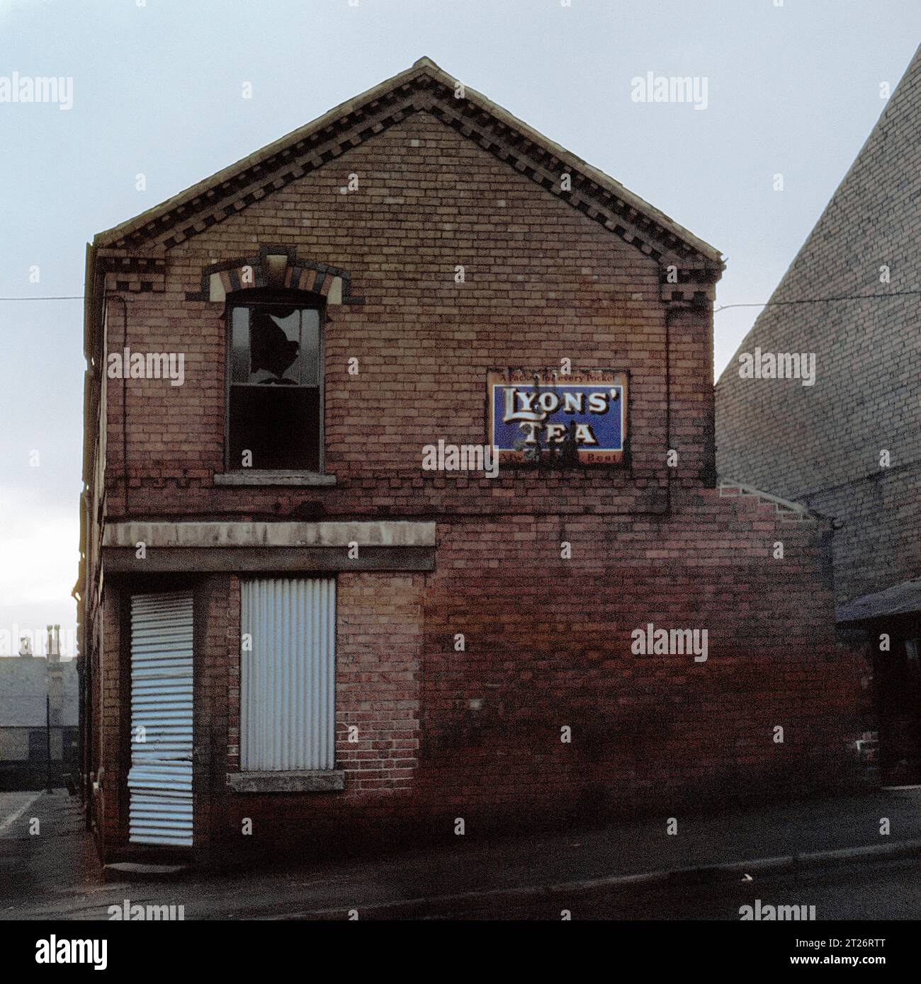 Boarded up shop with enamelled sign for 'Lyons Tea' mounted on the wall, during the Slum clearance and demolition of St Ann's, Nottingham. 1969-1972 Stock Photo