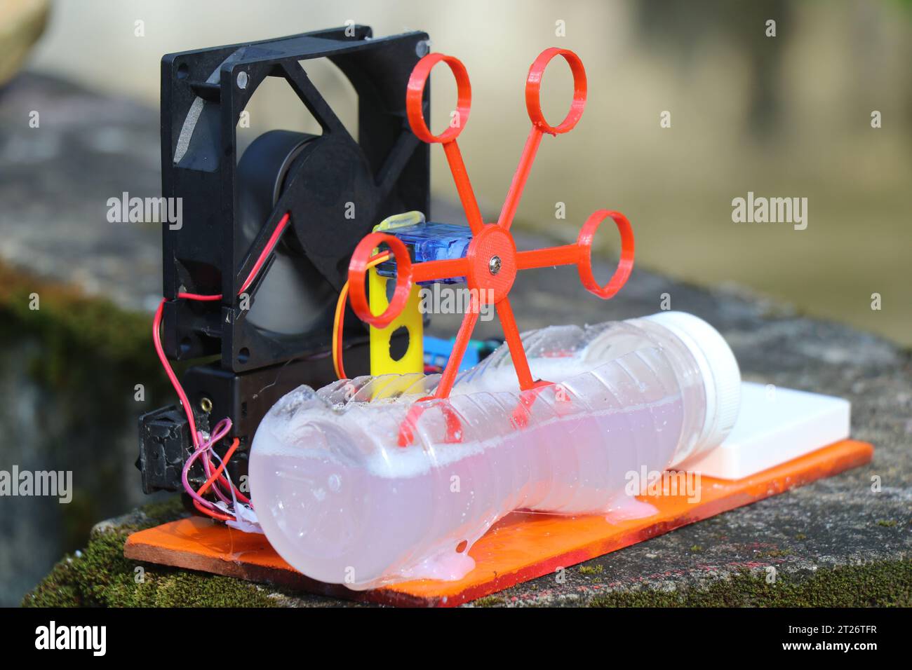 Bubble blower machine made at home using DC fan and 3D printed bubble generator dipped on a soap liquid and run by a servo Stock Photo