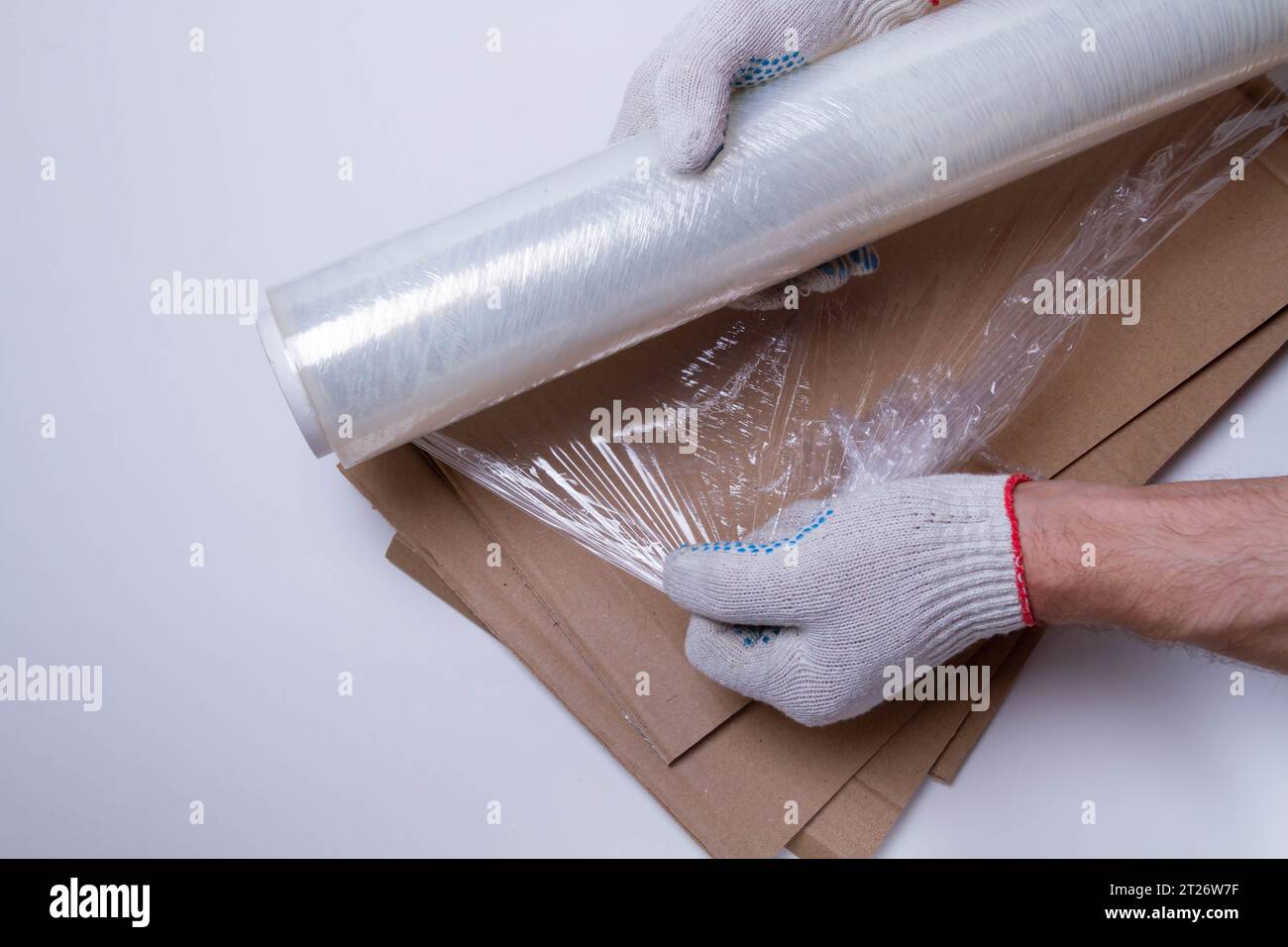 Packing the goods in a cardboard box and stretch film. Tools for