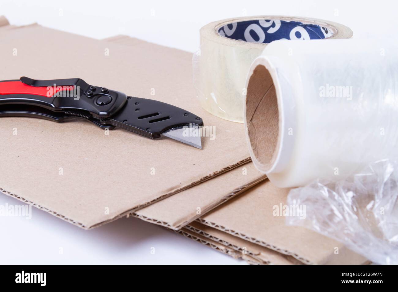 Packing the goods in a cardboard box and stretch film. Tools for