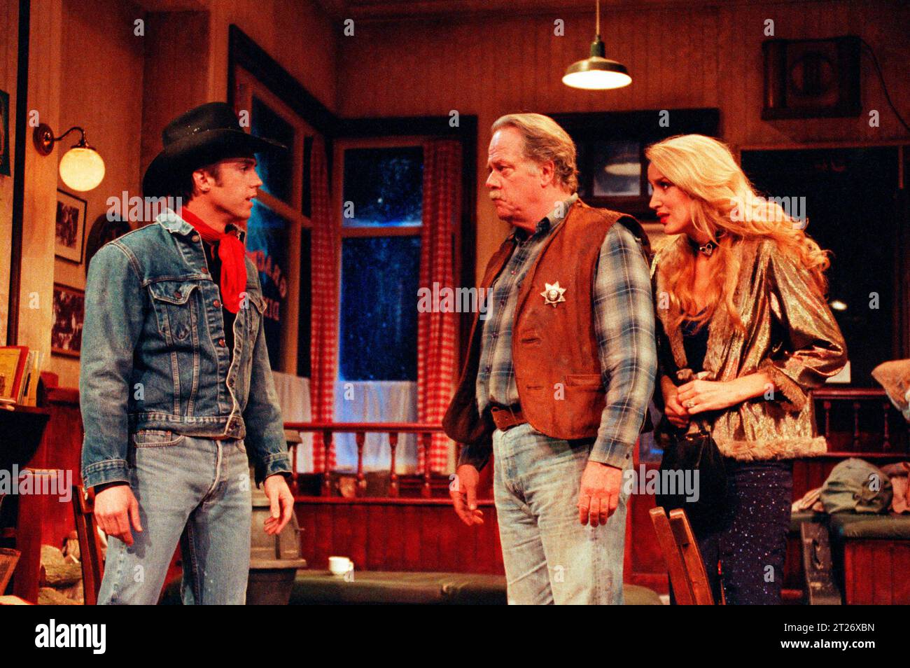l-r: Shaun Cassidy (Bo Decker), Bill Bailey (Will Masters), Jerry Hall (Cherie) in BUS STOP by William Inge at the Palace Theatre, Watford, England  02/1990  transferred to the Lyric Theatre, London W1  27/02/1990  design: Tim Goodchild  lighting: Jenny Cane  director: Phil Oesterman Stock Photo