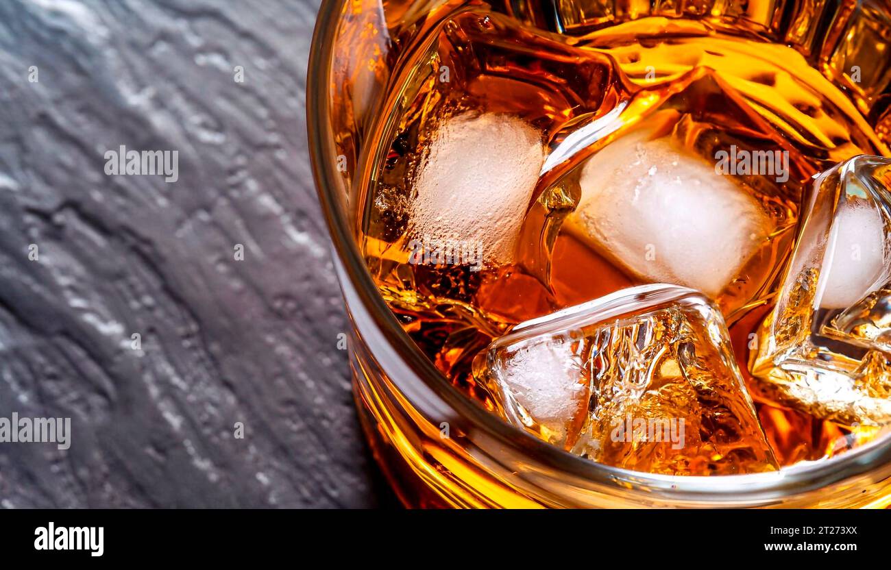 Whiskey being poured into a crystal glass. Top view. Golden liquid