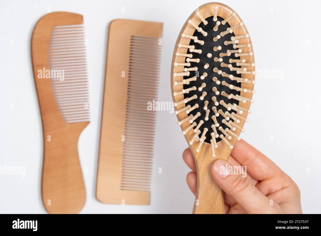 Wooden Comb In Woman's Hand, Natural Products In Hair Care Stock Photo