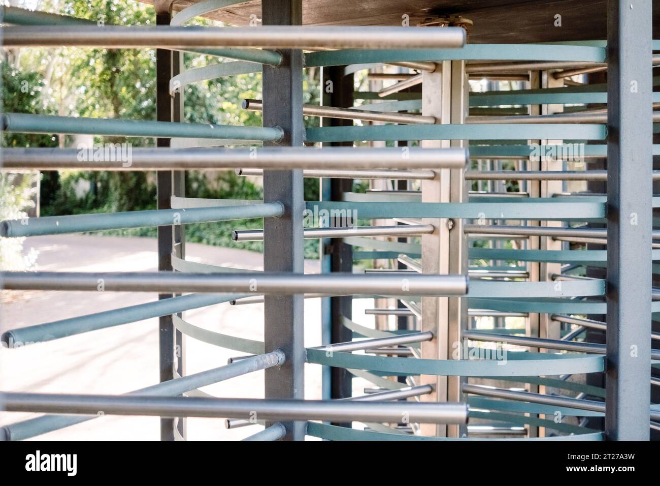 Controlled access revolving door with metal security bars Stock Photo ...