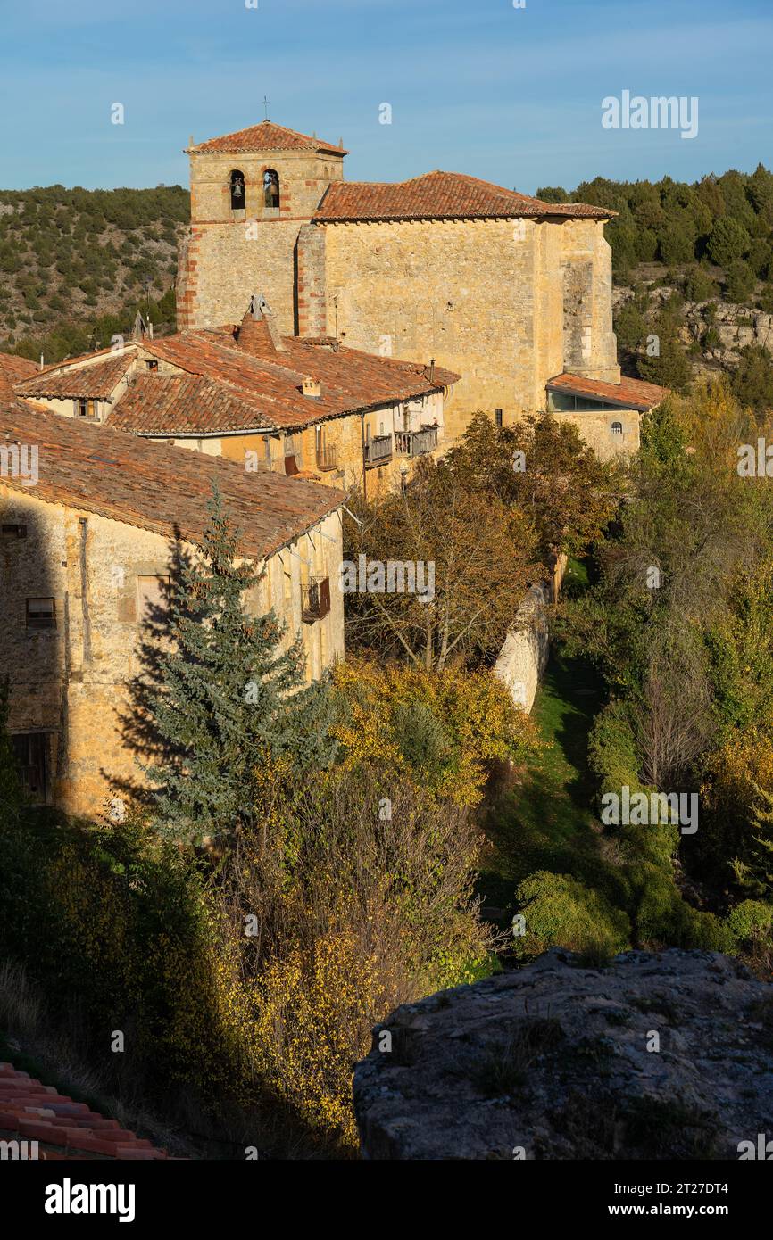 Aerial view of the traditional houses of the medieval village of Calatañazor and the church in a sunny day in Stock Photo