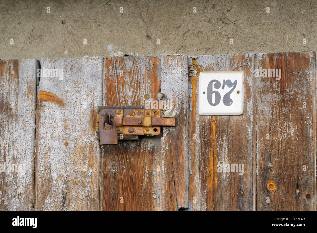 Rusty door latch with padlock Stock Photo