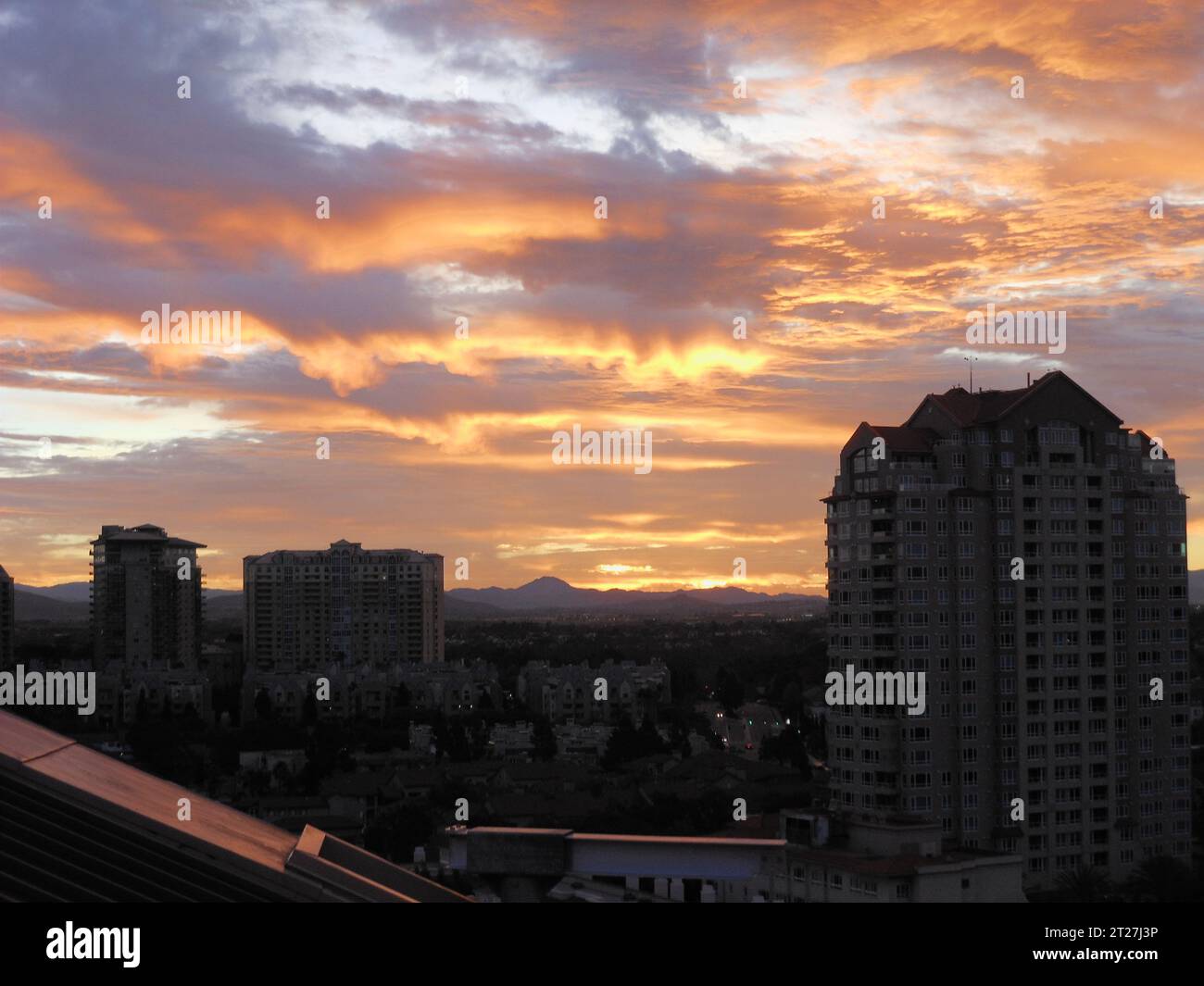 A stunning sunset viewed from a high-rise residential apartment ...