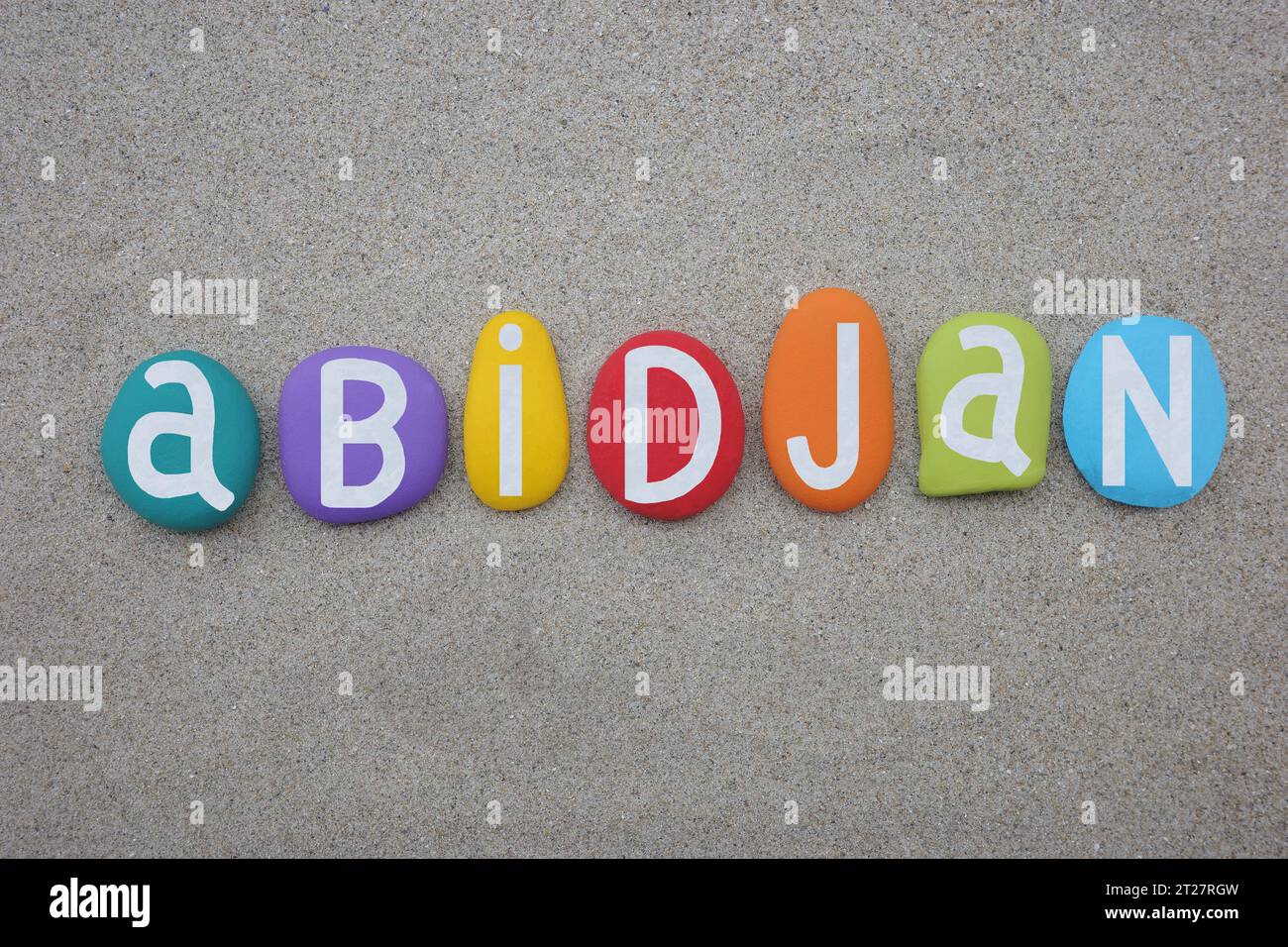 Abidjan, the largest city and the economic capital of the Ivory Coast, souvenir or logo composed with hand painted multi colored stone letters over be Stock Photo