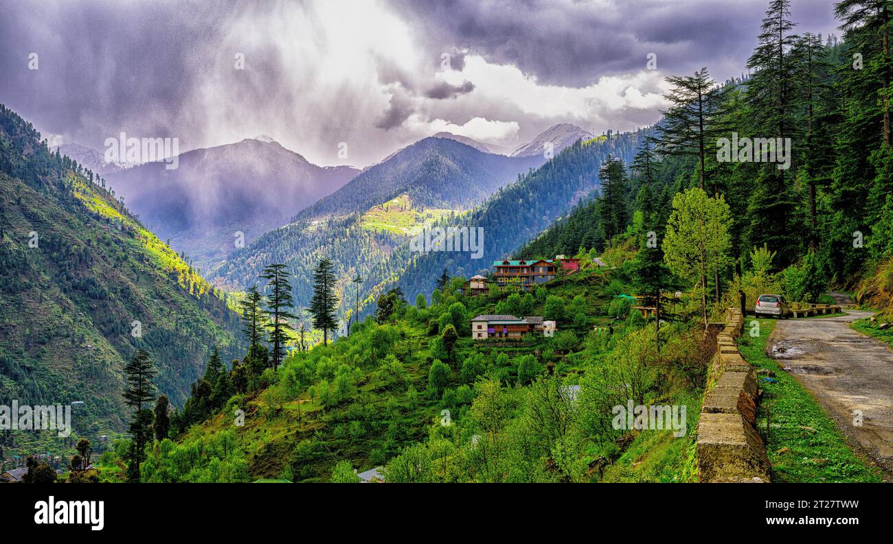 Sunlight breaking through the storm clouds in vicinity of Gushaini hamlet in the Tirthan Valley, Himachal Pradesh Stock Photo