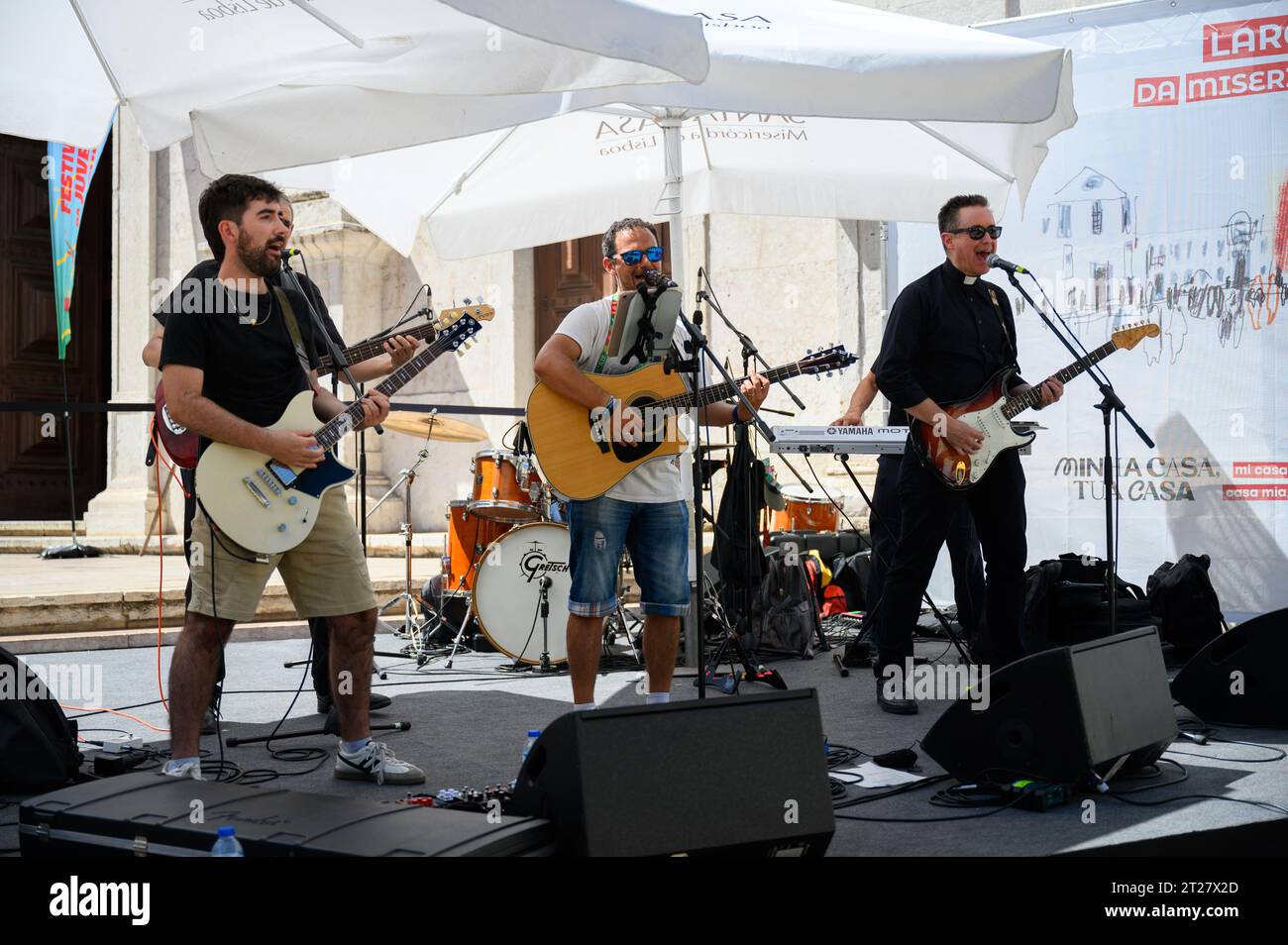 A band, including a catholic priest, giving a concert during World Youth Days 2023 in Lisbon, Portugal. The concert took place near the St Roch Church. Stock Photo