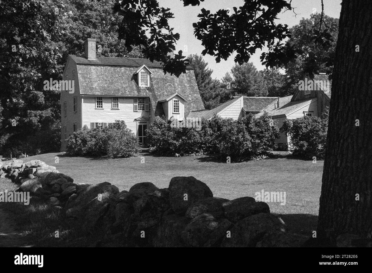 The historic Old Manse the home of Ralph Waldo Emerson and Nathaniel Hawthorne on the banks of the Concord River. The image was captured on black and Stock Photo
