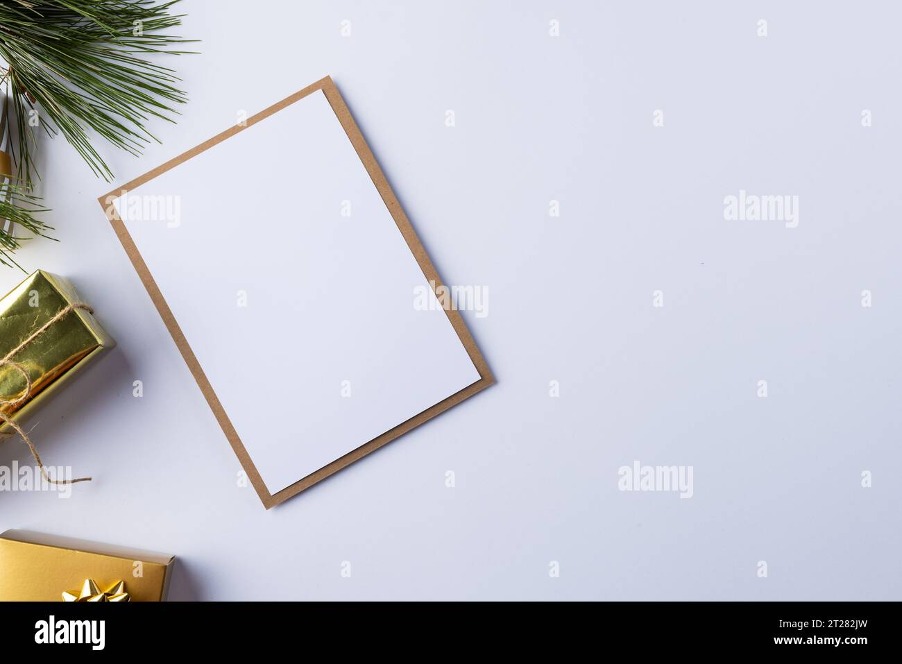 White card with copy space and christmas presents on white background ...