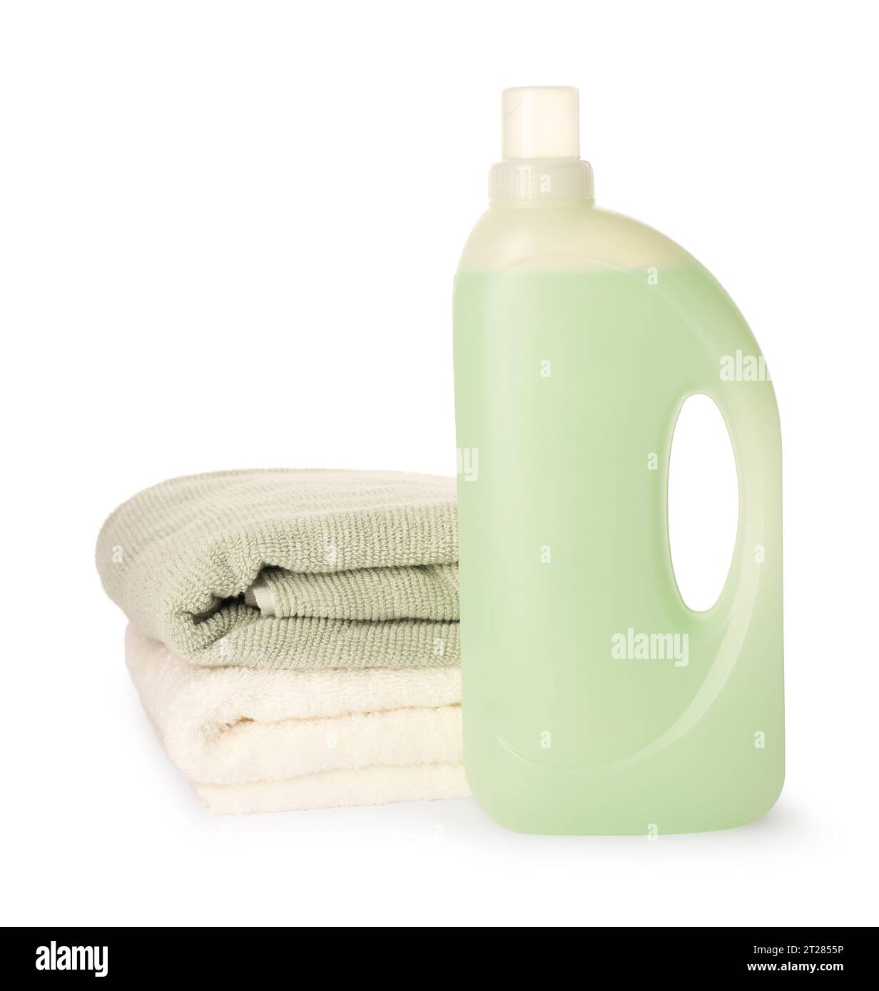 Bottle of fabric softener and stacked clean towels isolated on white
