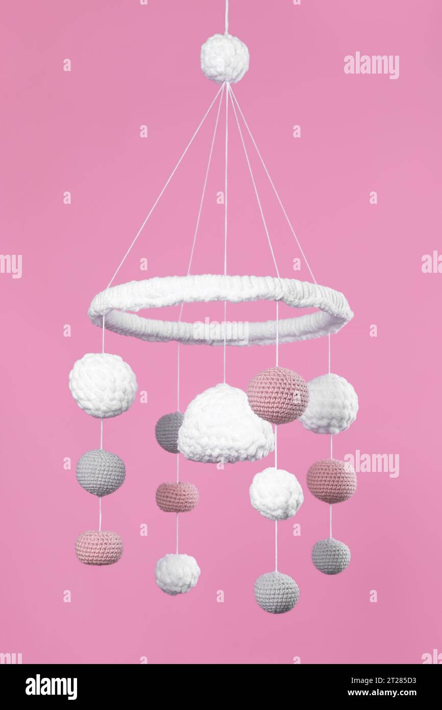 Cute baby crib mobile on pink background Stock Photo Alamy