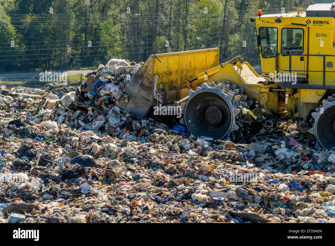 Heavy machinery is spreading the garbage at the King County Cedar Hills