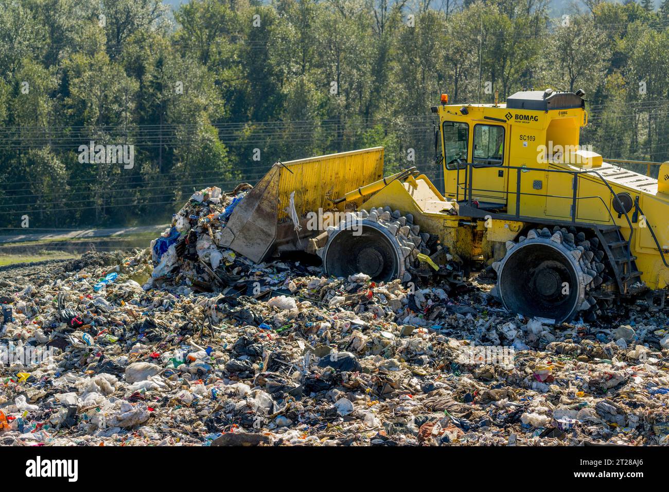 Heavy machinery is spreading the garbage at the King County Cedar Hills