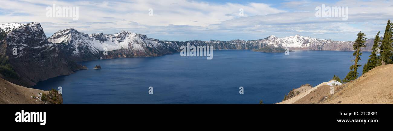 Panoramic View of Crater Lake with seasons first snow and Wizard Island and Phantom Ship Stock Photo