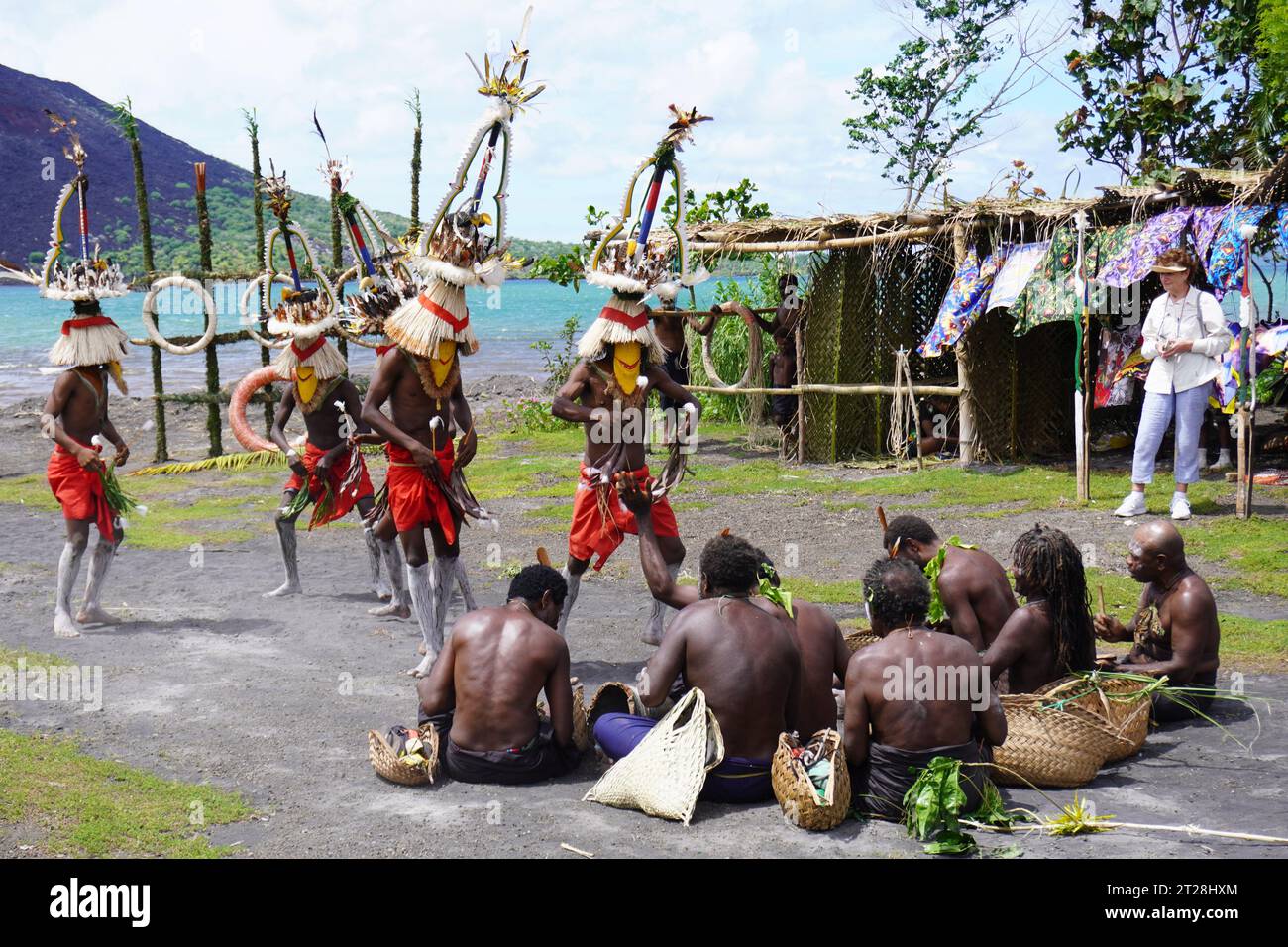 Masked Dancers performing in Front of Seated Musicians at a Mask Festival in Rabaul, Papua New Guinea Stock Photo