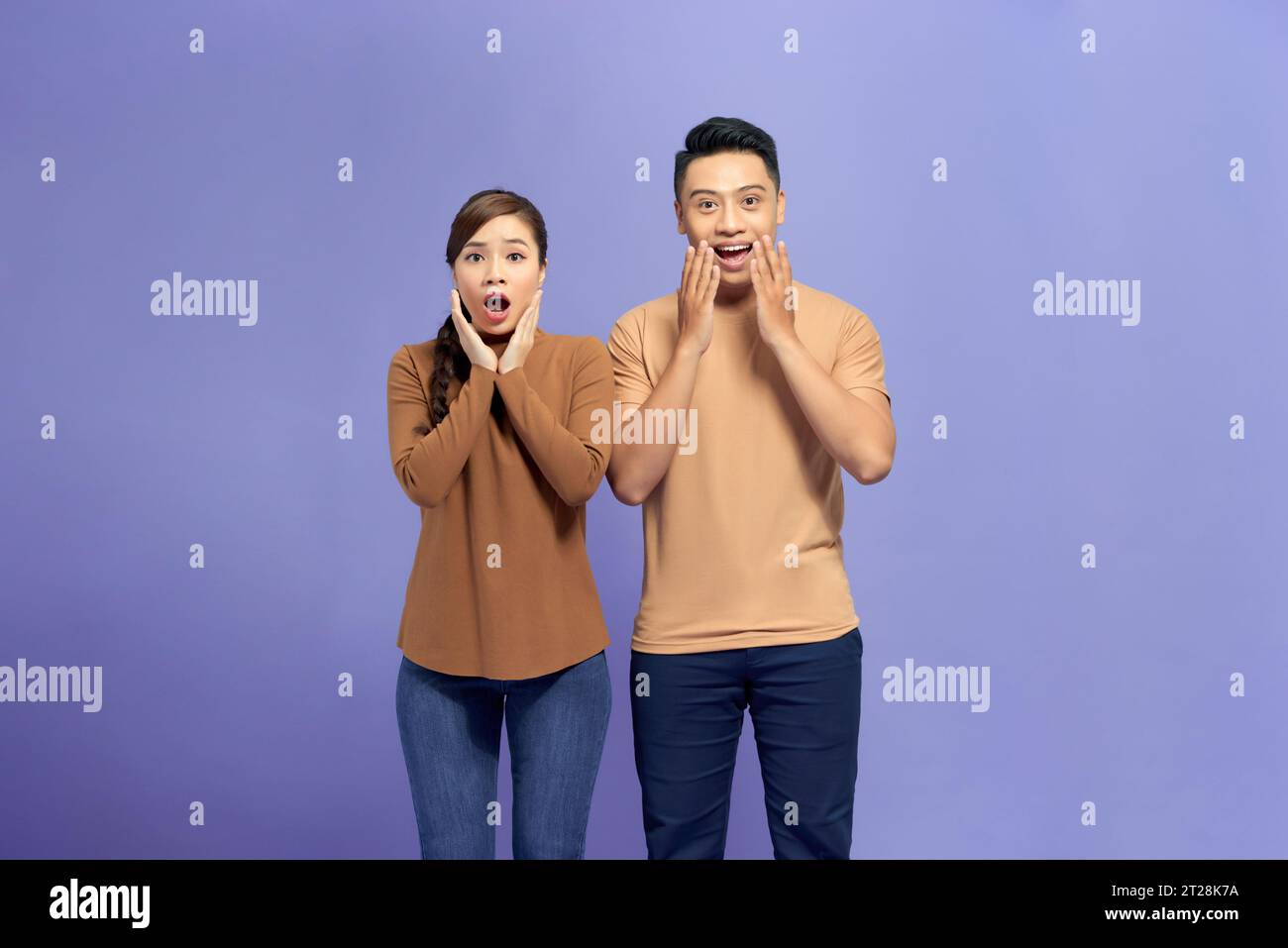 Two young surprised, funky lovers with wide opened mouth and eyes