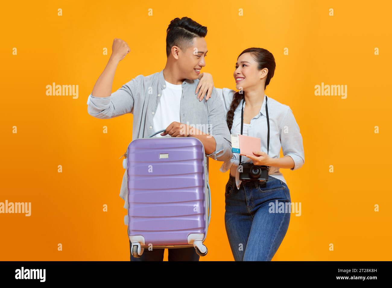 Happy young tourists couple friends man woman isolated on yellow ...