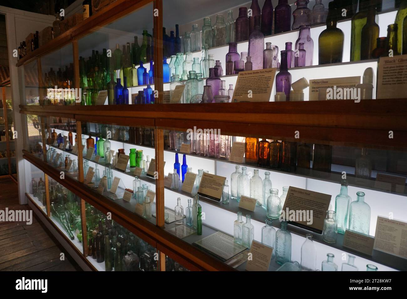 Display of old fashioned glass bottles in historical village outdoor museum in Herberton