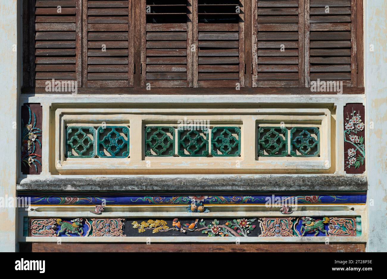Ancient house with traditional decorative in George Town. Heritage Chinese porcelain decor house in penang. Vintage wooden louvred shutters. Stock Photo