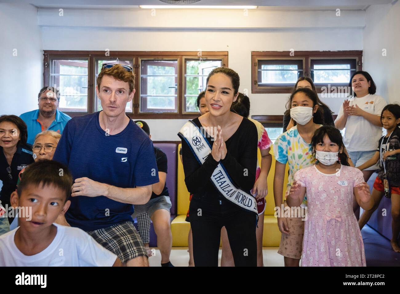 Bangkok, Thailand. 14th Oct, 2023. Tharina Botes, Miss Thailand World 2023 is seen among young children and adults from Klong Toei Bangkok's biggest slum, at the Bangkok Community Help Foundation Learning and Development Center, at Klong Toei, in Bangkok. Miss Thailand World 2023, Tharina Botes, mixed Thai-South African heritage joined as a volunteer in a free weekly English program for kids and adults, organized by the Bangkok Community Help Foundation, at Klong Toei, Bangkok's biggest slum. (Photo by Nathalie Jamois/SOPA Images/Sipa USA) Credit: Sipa USA/Alamy Live News Stock Photo