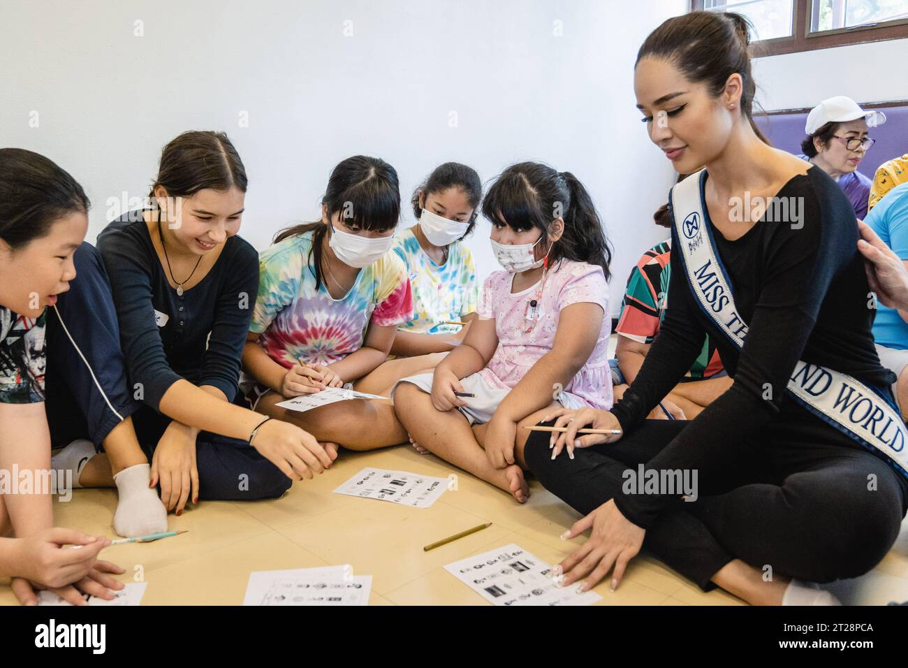 Bangkok, Thailand. 14th Oct, 2023. Tharina Botes, Miss Thailand World 2023 is seen teaching English to young children from Klong Toei Bangkok's biggest slum, at the Bangkok Community Help Foundation Learning and Development Center, at Klong Toei, in Bangkok. Miss Thailand World 2023, Tharina Botes, mixed Thai-South African heritage joined as a volunteer in a free weekly English program for kids and adults, organized by the Bangkok Community Help Foundation, at Klong Toei, Bangkok's biggest slum. (Photo by Nathalie Jamois/SOPA Images/Sipa USA) Credit: Sipa USA/Alamy Live News Stock Photo
