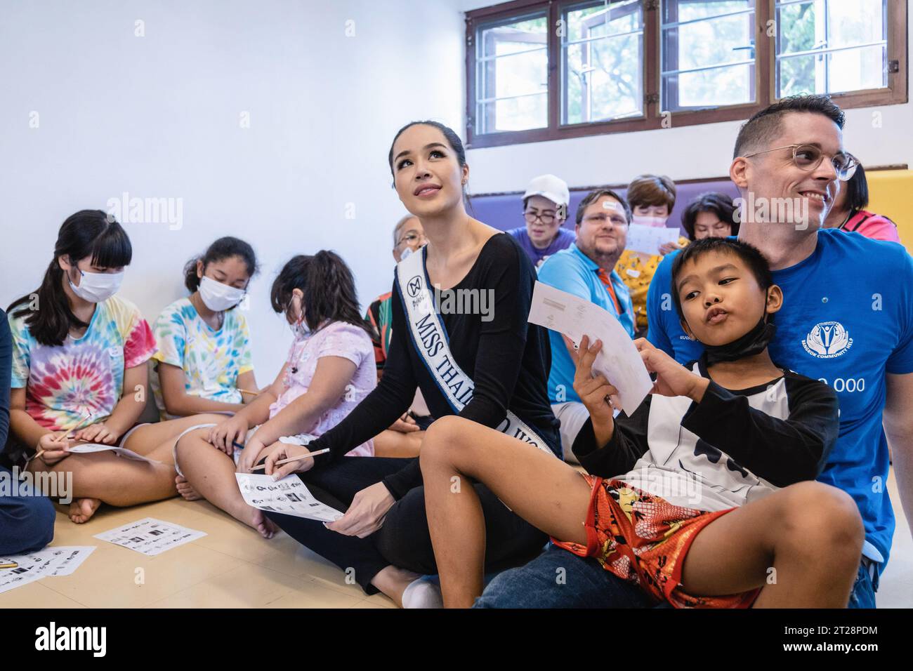 Bangkok, Thailand. 14th Oct, 2023. Tharina Botes, Miss Thailand World 2023 is seen during a free English program to help the children of Klong Toei Bangkok's slum at the Bangkok Community Help Foundation Learning and Development Center, at Klong Toei, in Bangkok. Miss Thailand World 2023, Tharina Botes, mixed Thai-South African heritage joined as a volunteer in a free weekly English program for kids and adults, organized by the Bangkok Community Help Foundation, at Klong Toei, Bangkok's biggest slum. (Photo by Nathalie Jamois/SOPA Images/Sipa USA) Credit: Sipa USA/Alamy Live News Stock Photo