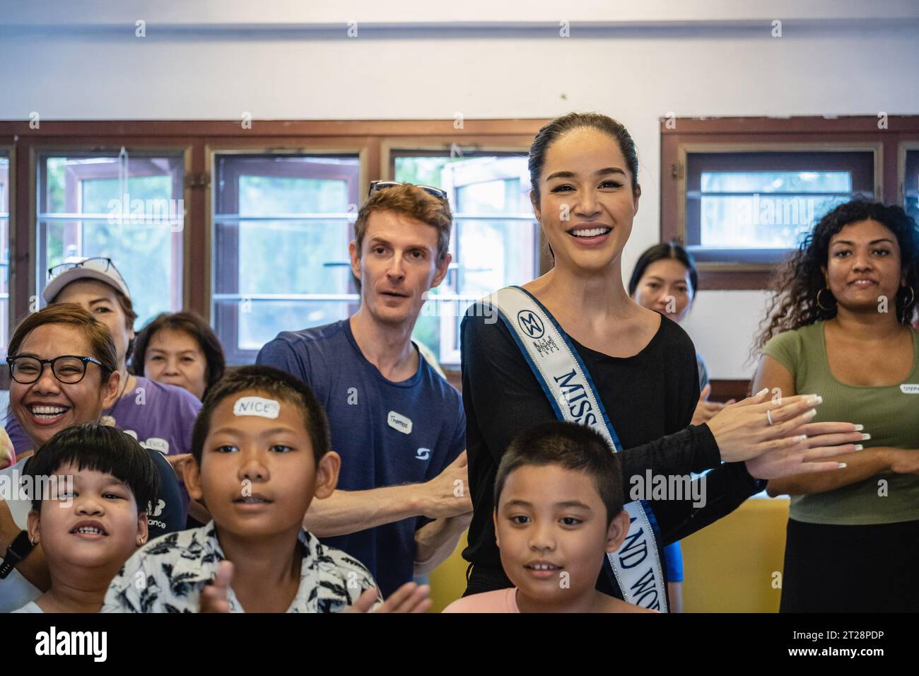 Bangkok, Thailand. 14th Oct, 2023. Tharina Botes, Miss Thailand World 2023 is seen with young children from Klong Toei Bangkok's biggest slum, at the Bangkok Community Help Foundation Learning and Development Center, at Klong Toei, in Bangkok. Miss Thailand World 2023, Tharina Botes, mixed Thai-South African heritage joined as a volunteer in a free weekly English program for kids and adults, organized by the Bangkok Community Help Foundation, at Klong Toei, Bangkok's biggest slum. (Photo by Nathalie Jamois/SOPA Images/Sipa USA) Credit: Sipa USA/Alamy Live News Stock Photo