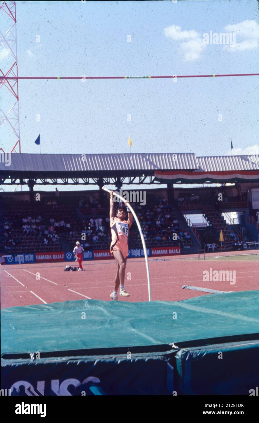 The pole vault is an event in which an athlete jumps over a high bar using a pole, which is classified as one of the jumping events in track and field athletics. The pole vault technique comprises of the following phases: approach, plant, take-off, penetration, rock back, stretch turn, bar clearance and landing. The right-handed vaulter grips the top end of the pole with his right hand. Stock Photo