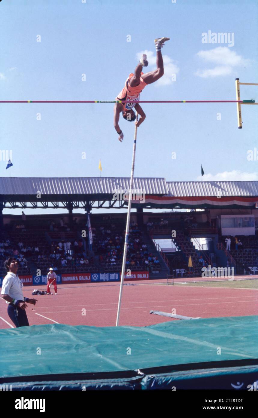 The pole vault is an event in which an athlete jumps over a high bar using a pole, which is classified as one of the jumping events in track and field athletics. The pole vault technique comprises of the following phases: approach, plant, take-off, penetration, rock back, stretch turn, bar clearance and landing. The right-handed vaulter grips the top end of the pole with his right hand. Stock Photo