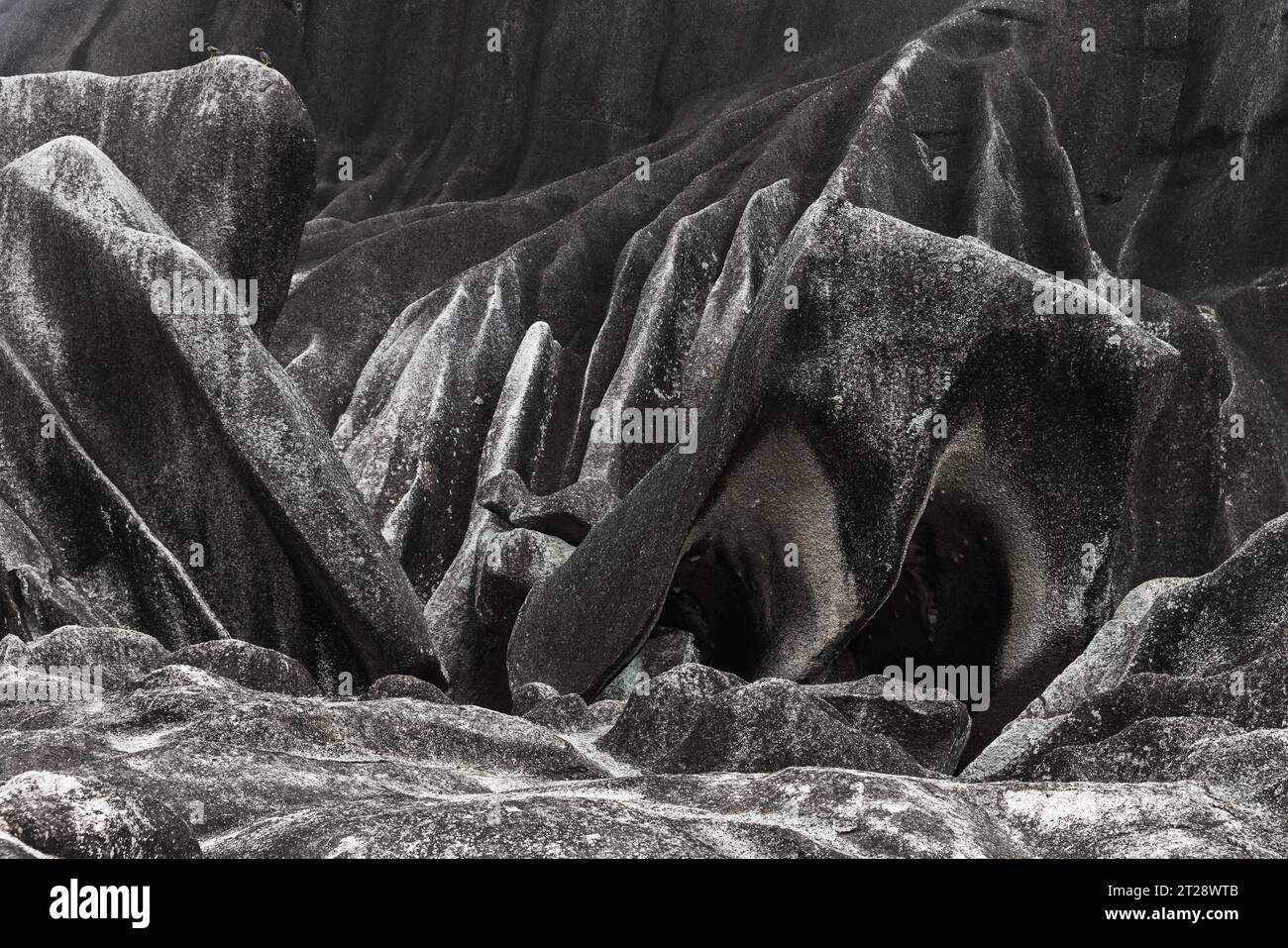 Black stones of the Giant Union Rock. Popular natural landmark of La Digue island, Seychelles Stock Photo