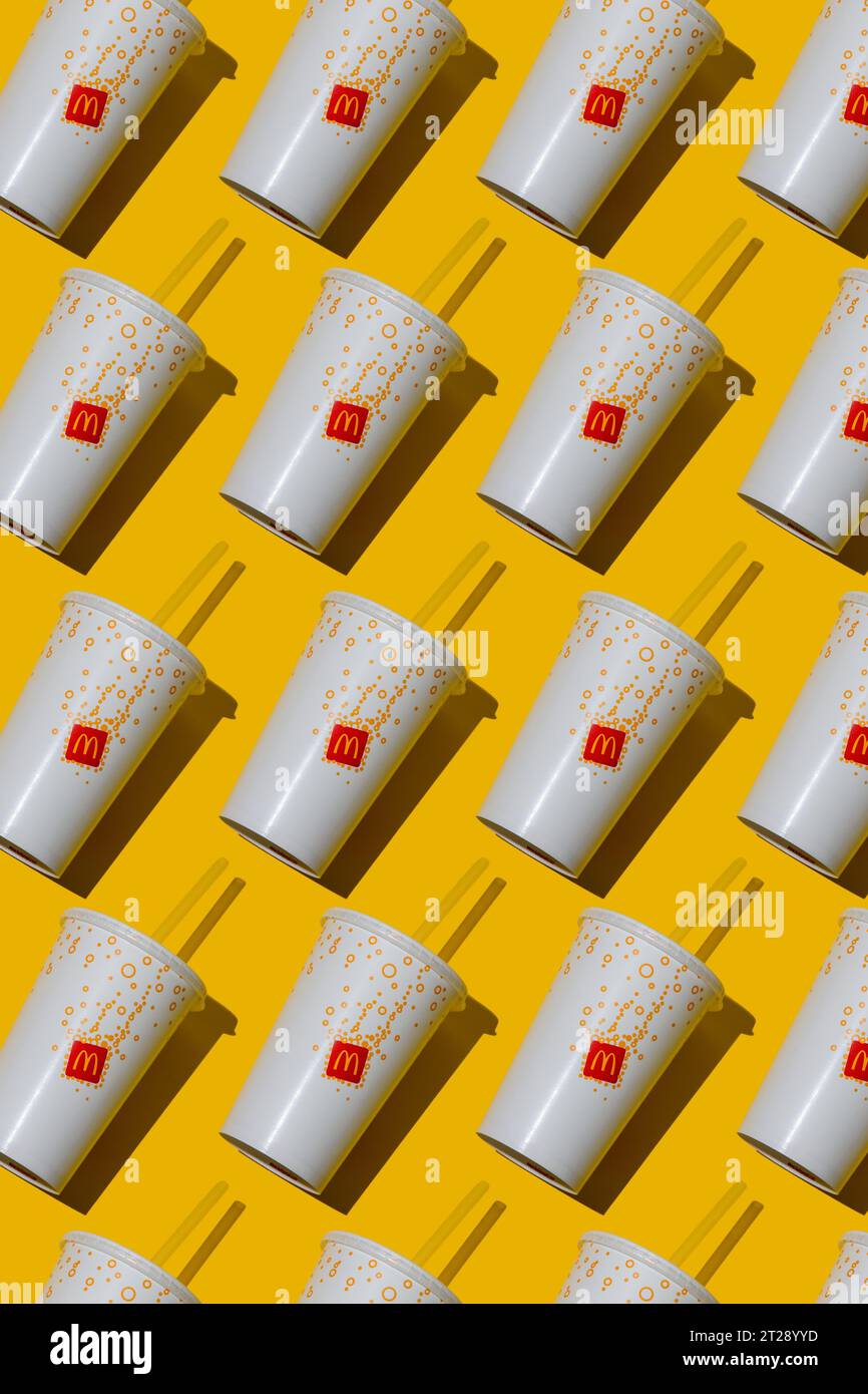 Yellow glass of McDonald's. Paper cup with lid. Takeaway drink ...