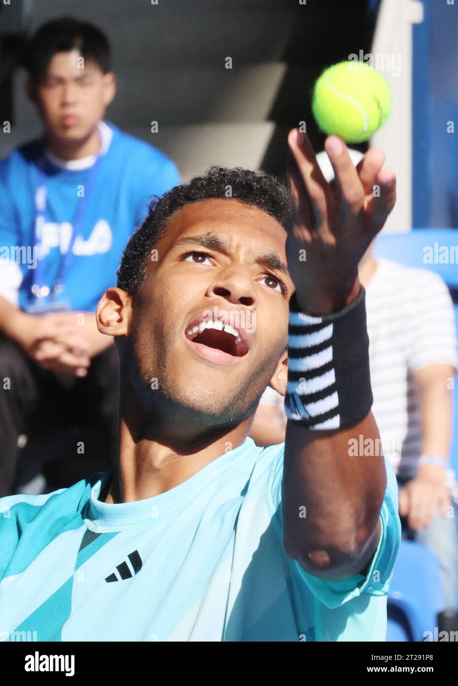 Tokyo, Japan. 18th Oct, 2023. Felix AugerAliassime of Canada tosses the ball to deliver a