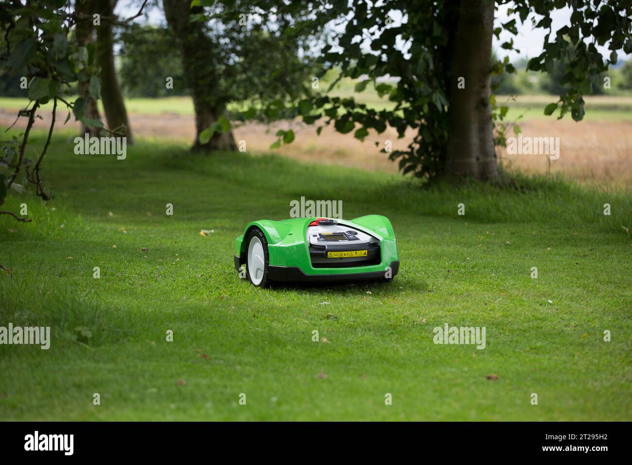 An iMow automated lawn mower in a garden in the UK Stock Photo