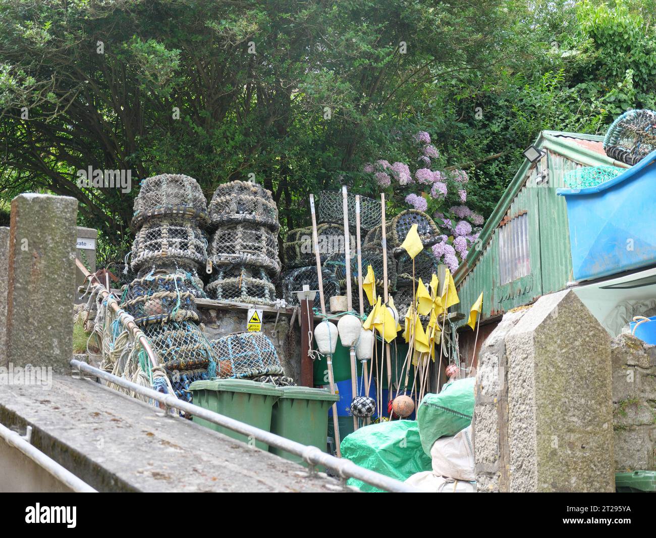 Lobster trap and buoy marker flags in a fishing yard in Mousehole in