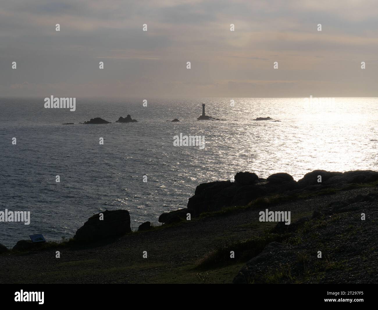 Sunset on steep cliff with offshore rocks of Land's End, Cornwall ...