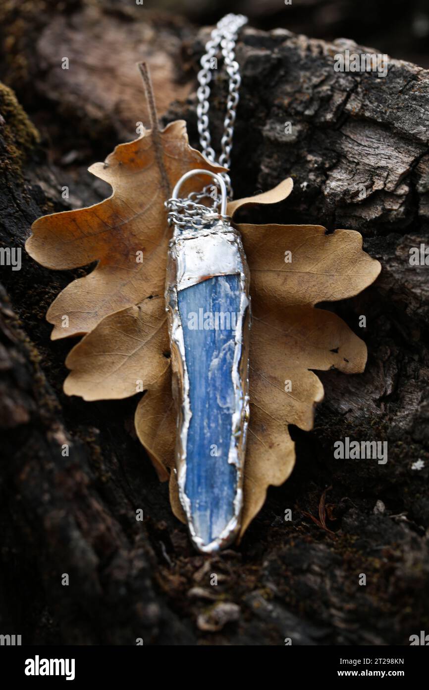 Raw kyanite pendant embraced by silver.  Gemstone with a strong calming effect on the whole being, it gives inner tranquility and peace, an energy amp Stock Photo