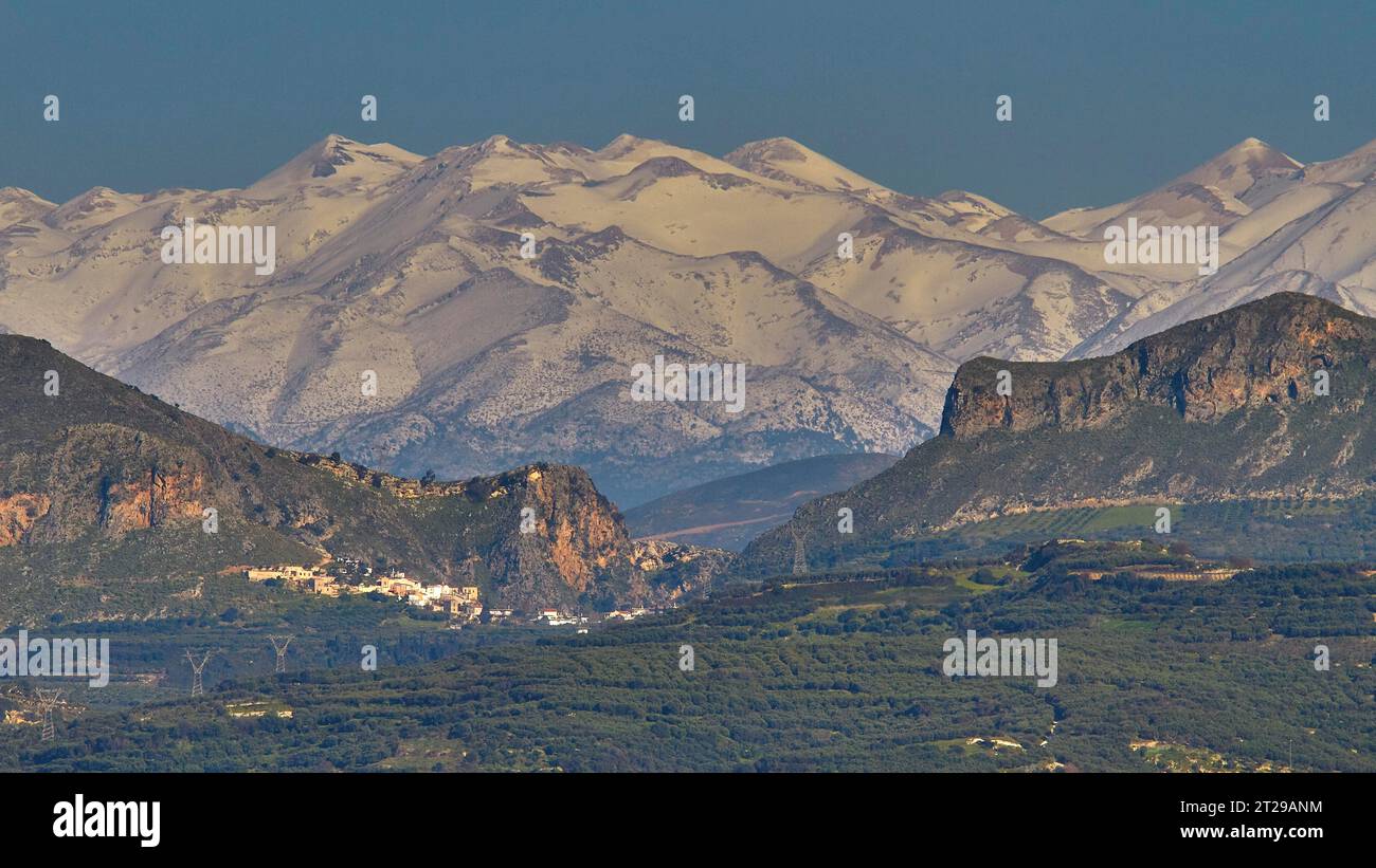 Winter, promontory, village, olive groves, gorge, snow-capped White Mountains, Lefka Ori, Chania Province, Crete, Greece Stock Photo