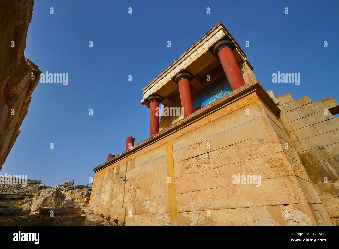 Super wide angle, oblique aerial view, Minoan palace building, red columns, bull fresco, Palace of Knossos, blue cloudless sky, Knossos, Heraklion Stock Photo