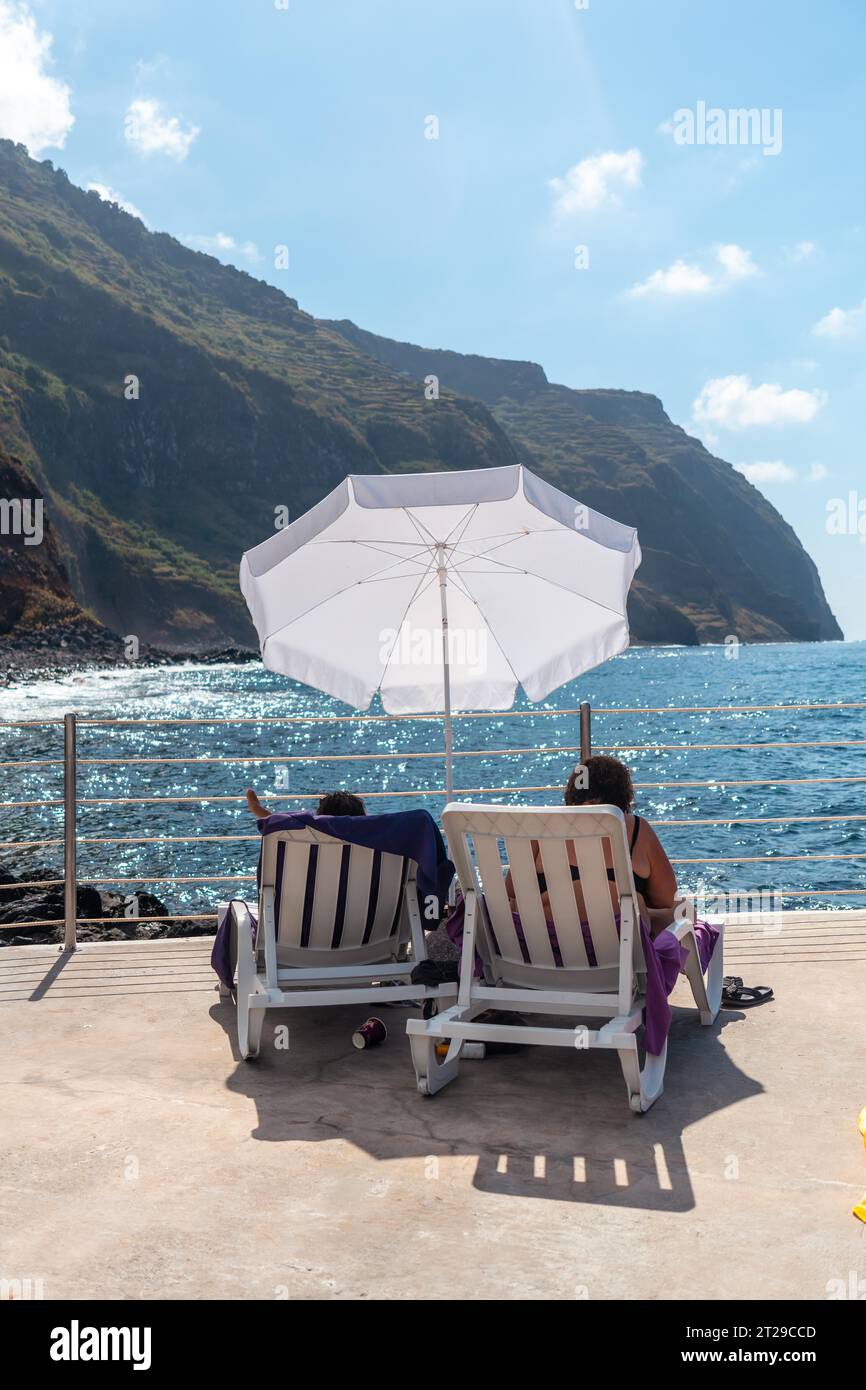 Porto Moniz coastal town, resting in the natural pools enjoying the summer, Madeira Stock Photo