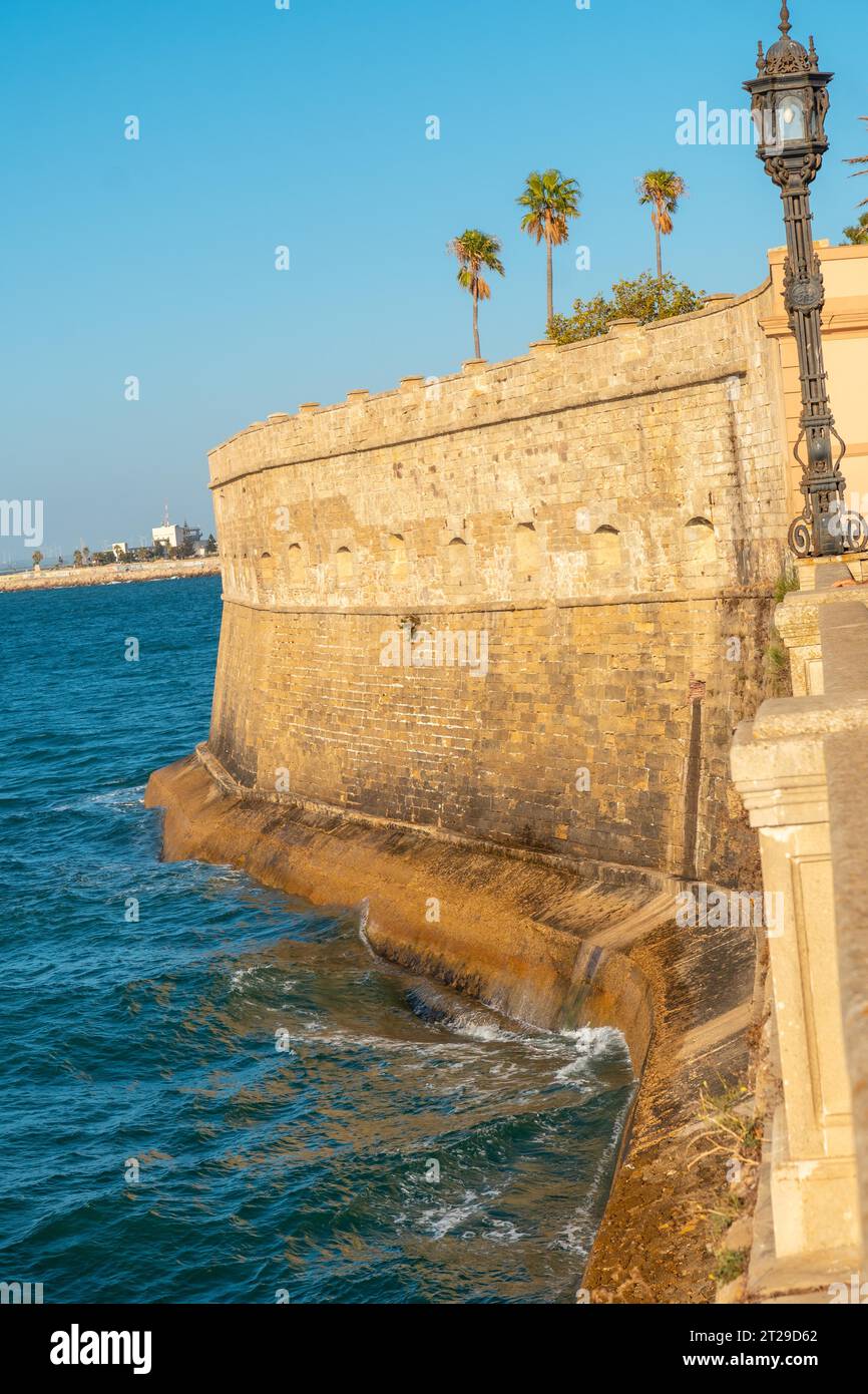 Walls and sea coast of the Baluarte de la Candelaria in the city of Cadiz. Andalusia Stock Photo