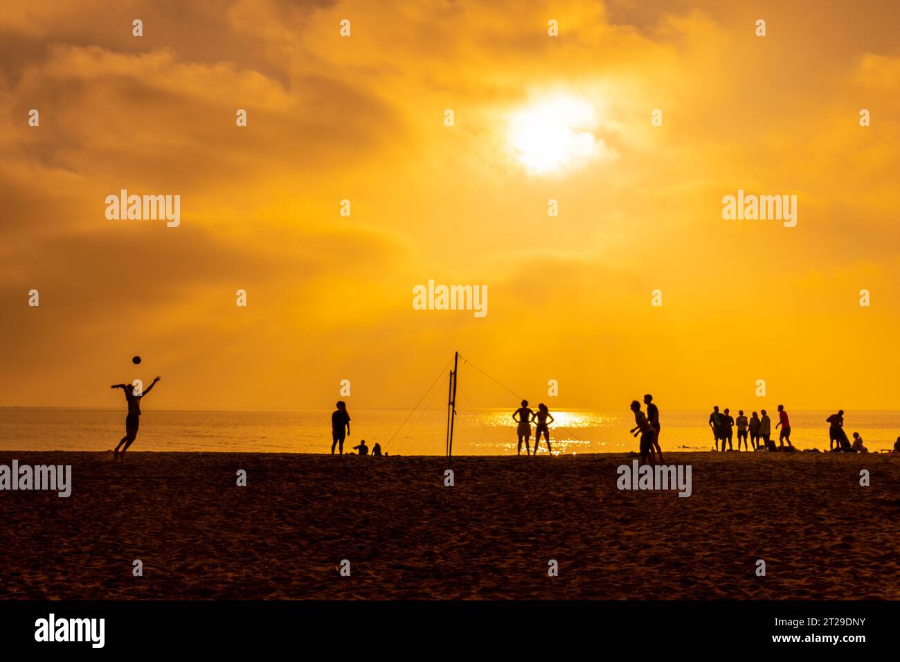 Some young people playing volleyball on the beach of San Miguel in the city of Almeria, Andalusia. Spain. Costa del sol in the mediterranean sea Stock Photo